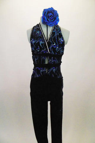 Black velvet based unitard has halter front with open center & leg design. Top has swirls of blue-silver lined with crystals.  2 black bands wrap around back. Comes with large blue floral accessory. Front