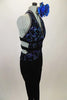 Black velvet based unitard has halter front with open center & leg design. Top has swirls of blue-silver lined with crystals.  2 black bands wrap around back. Comes with large blue floral accessory. Right side