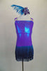 Iridescent purple-blue leotard has layered teal fringe skirt. Bodice is covered in crystals as are the triple shoulder straps. Comes with feather hair accessory. Front