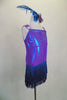 Iridescent purple-blue leotard has layered teal fringe skirt. Bodice is covered in crystals as are the triple shoulder straps. Comes with feather hair accessory. Side