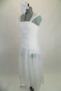 Soft, sheer white gossamer dress has sheer flowing skirt & ruching in front center of bodice, Has wide gossamer shoulder straps and floral hair accessory. Left side