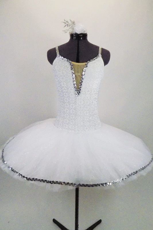 Professional pancake tutu has all white pleated tutu with silver sequin edging. White stretch bodice has silver  print with deep plunge bodice & crystal straps. Comes with hair accessory. Front