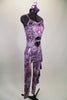 Iridescent purple animal print camisole unitard has chiffon ruffles down the left leg. Stomach area is open with crystalled band. Comes with hair accessory. Right side