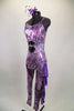 Iridescent purple animal print camisole unitard has chiffon ruffles down the left leg. Stomach area is open with crystalled band. Comes with hair accessory. Left side