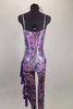 Iridescent purple animal print camisole unitard has chiffon ruffles down the left leg. Stomach area is open with crystalled band. Comes with hair accessory. Back