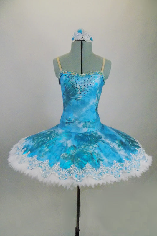 Professional hooped & tacked platter tutu has floral overlay in shades of turquoise. Tutu is edged with wide pearled bridal lace. Comes with hair accessory Front