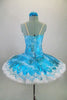Professional hooped & tacked platter tutu has floral overlay in shades of turquoise. Tutu is edged with wide pearled bridal lace. Comes with hair accessory. Back