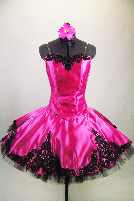 Pink satin boned bodice with black beaded lace has matching satin wide lace scalloped overlay. Overlay sits on top of a black pleated & tacked tutu. Comes with hair accessory. Front