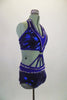 2-piece electric blue sequined costume is attached in at the front midriff by a series of straps. The costume is lines entirely with pointy metal studs. Comes with matching hair accessory. Side