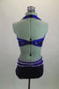 2-piece electric blue sequined costume is attached in at the front midriff by a series of straps. The costume is lines entirely with pointy metal studs. Comes with matching hair accessory. Back