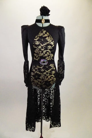 Gothic inspired black leotard dress has nude front center insert with floral lace & pouf shouldered long lace bishop sleeves. The long lace skirt has crystal belt buckle accent. Comes with hair accessory and jeweled choker. Front