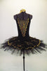 Black platter pull-on tutu with black & gold scalloped lace overlay compliments the matching leotard with gold lace front insert. Comes with gold hair barrette. Front