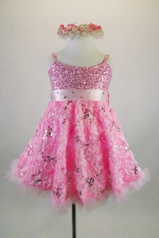 Pink rose floral sequined lace print A-line dress has wide satin, crystal covered satin band that snaps at back with bow. Comes with beaded -floral head wreath. Front