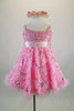 Pink rose floral sequined lace print A-line dress has wide satin, crystal covered satin band that snaps at back with bow. Comes with beaded -floral head wreath. Front