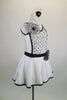 Shiny white lycra dress has low scoop back & black banding covered with crystals. Front torso is sheer ruched white & black polka dots. Has dotted daisy accents. Right side