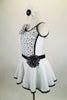 Shiny white lycra dress has low scoop back & black banding covered with crystals. Front torso is sheer ruched white & black polka dots. Has dotted daisy accents. Left side