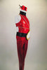 Red glitter lycra unitard has high neck, open sides & zip back. Large fabric clock sits at the left hip with gold chains. Comes with dynamite hair accessory. Right side