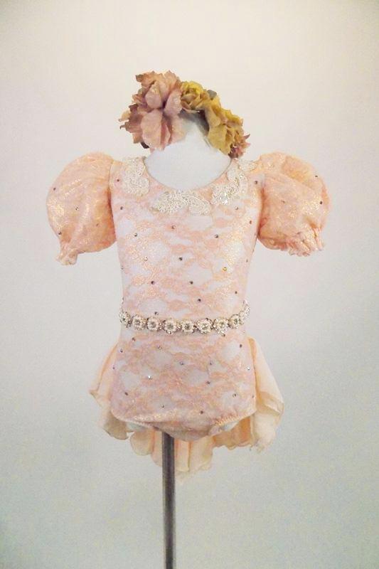 Leotard with blush lace & golden undertones has open back, large lace pouf sleeves & bridal applique The chiffon bustle & pearled belt finish the look. Comes with antiqued rose hair band. Front