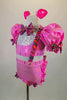 Pink piggy-themed 2-piece costume has pouf sleeved half top with keyhole back & laced back. Matching short has back ruffles, curly tail & attached suspenders.  Comes with clip-on ears. Left side