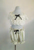 2-piece ivory lace costume resembles vintage undergarments. Bottom is pouffy bloomers & bra top has lace ruffled, front, corset  lace-up back & drop shoulders. Comes with large hair accessory. Front