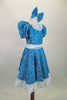 Blue brocade motif glitter velvet 2-piece costume has pouf sleeved leotard with lace collar. The matching knee-length skirt has lace trim & waistband with bow. Comes with matching hair bow. Side