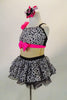 Black & white spotted chiffon dress has nude mesh mid-torso, black sequin back and bright pink band with crystal covered bow at bust & chiffon crinoline skirt. Comes with matching hair accessory. Left side