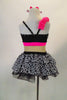Black & white spotted chiffon dress has nude mesh mid-torso, black sequin back and bright pink band with crystal covered bow at bust & chiffon crinoline skirt. Comes with matching hair accessory. Back