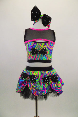 2-piece costume has bright neon swirls. The half-top has a black crystaled bow & mesh upper shrug with pink trim. Skirt has crystaled bows & tulle crinoline. Comes with matching headband. Front