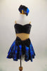 Black & blue 2-piece costume has black bust, nude mesh torso & attached blue skirt with bow at front. Comes with pouf sleeved bolero jacket & crystal button. Front without jacket