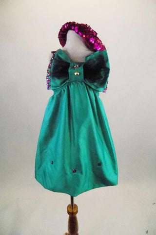 Green taffeta smocked back bubble dress has large crystaled bow accent that covers the bust & pink crystal accents. Comes with pink sequined beret & pink gloves. Front