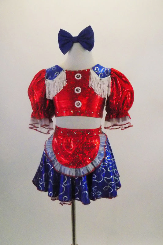 2-piece costume has a bright red half top with pouf sleeves, white fringed blue lasso print epaulets & buttons. Matching skirt has crinoline & red apron. Comes with blue hair bow. Front