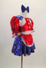 2-piece costume has a bright red half top with pouf sleeves, white fringed blue lasso print epaulets & buttons. Matching skirt has crinoline & red apron. Comes with blue hair bow. Side
