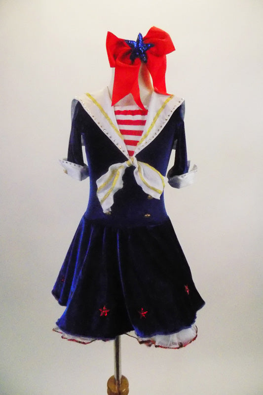 Dark blue velvet dress has white crinoline & red star accents. The large white naval collar has front tie & striped inlay. Collar hash gold piping & red stars. Comes with large red hair bow. Front