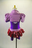 Purple short leotard has attached pink sequined short skirt with lavender waistband. The accompanying lavender shrug has pouf sleeves & crystaled purple piping. Comes with purple hair accessory. Back