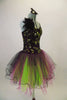 Magenta purple based dress has black lace overlay with lime green sequins & feather accent at right shoulder. The tulle skirt is layers of lime magenta & black. Comes with matching feather hair accessory. Right side