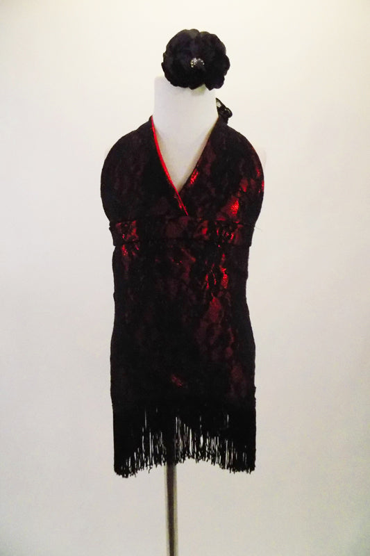 Black lace salsa dress has halter lace tie neck & shiny red base. Dress has wide fringe bottom edge and open back with strap. Comes with floral hair accessory. Front