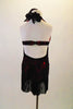 Black lace salsa dress has halter lace tie neck & shiny red base. Dress has wide fringe bottom edge and open back with strap. Comes with floral hair accessory. Back