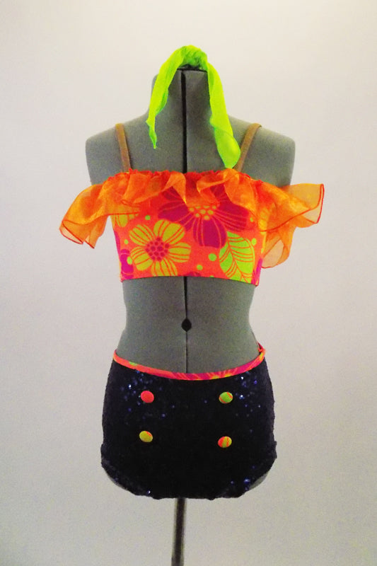 Bright neon colored floral print off-shoulder half top, has orange taffeta ruffle & nude reinforcing straps. Navy sequined brief has neon buttons & waistband. Comes with neon green hair scarf. Front