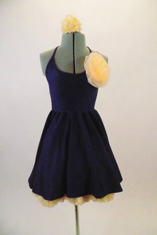 Navy blue halter stretch dress has a separate full multi-layered cream-colored petticoat. Has a large cream-colored flower accent at the left bust and hair. Front