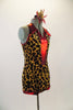 Leopard print halter leotard has V-neck front and keyhole back. The edging and center front are bright red metallic. Comes with matching hair accessory. Side