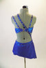 Iridescent blue metallic 2-piece costume has bra and angled skirt with attached panty & crystalled elastic straps crossing from right hip over torso & back. Comes with hair accessory. Back