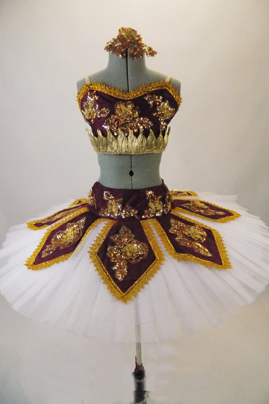 Professional hooped & tacked pleated tutu has a burgundy peaked overlay and basque with 3-D gold floral beaded appliques & brocade edging. Matching bodice half-top has gold leaf band & gold floral applique. Comes with a gold appliqued hair accessory. Front