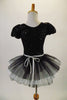 Cute French waitress inspired costume is a black sequined short unitard with pouffe sleeves & shiny white front accented with black buttons. The bustle skirt of crisp black & white pleated tulle gives the costume a sweet accent & is complemented by a small white sequined apron. Comes with adjustable chef hat & gloves. Back