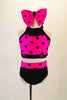 Two-piece costume has a pink halter half top with black polka dots, sequined band and fringed collar. The matching black brief has polka dot waistband. Comes with large pink polka dot hair bow. Front     