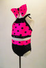 Two-piece costume has a pink halter half top with black polka dots, sequined band and fringed collar. The matching black brief has polka dot waistband. Comes with large pink polka dot hair bow. Side