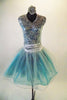 Sparking silver tutu dress has sleeveless sequined bodice with V-front and keyhole back. The attached turquoise and silver tulle skirt with silver cummerbund balances the sparkly bodice. Comes with hair accessory. Front