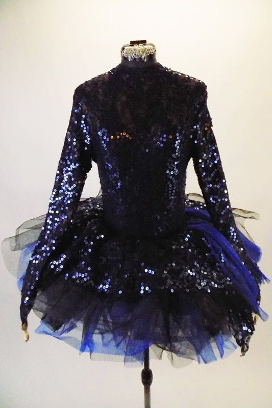 3-piece costume is a navy/royal blue full sequined leotard with long sleeves & key-hole back. The leotard is accompanied by navy shorts with sequin & chiffon cascading sashes at the right hip. There is a pull-on tutu skirt with stiff black & blue tulle layers with a sequined overlay. Comes with hair accessory. Front