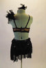 2-piece costume has an antique gold half top with black velvet swirls. There is a diagonal crystalled strap the rests on the chest between the two shoulder straps with a feather accent at the left shoulder. The accompanying black velvet shorts have lace and crystal accented wide waistband with cascading scarf belt Comes with antique gold and feather hair accessory. Back