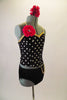 Two-costume has black and white polka dot camisole top with gold piping and jewelled flower accent at right shoulder. The matching black briefs have a chain accent at the left hip. Comes with matching hair accessory. Side