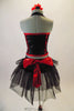 Back halter corset with red piping and a front bow is accompanied by black fully fringed shorts with black tulle bustle with a large red back bow. Comes with red and black floral hair accessory. Back